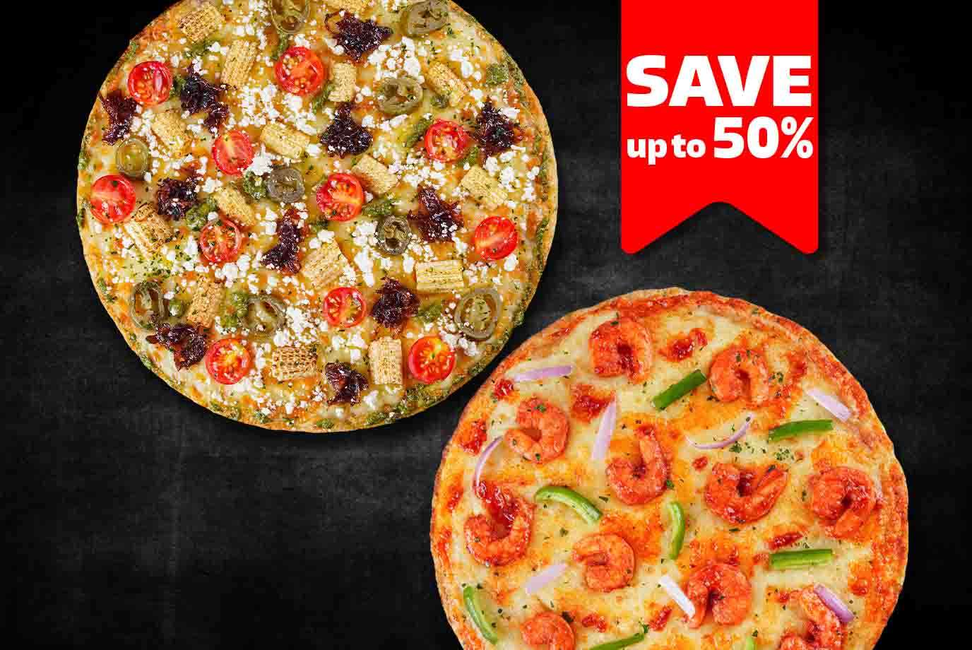 Buy One Get One - 1 Veg & 1 Non-Veg Medium Pizzas at 599